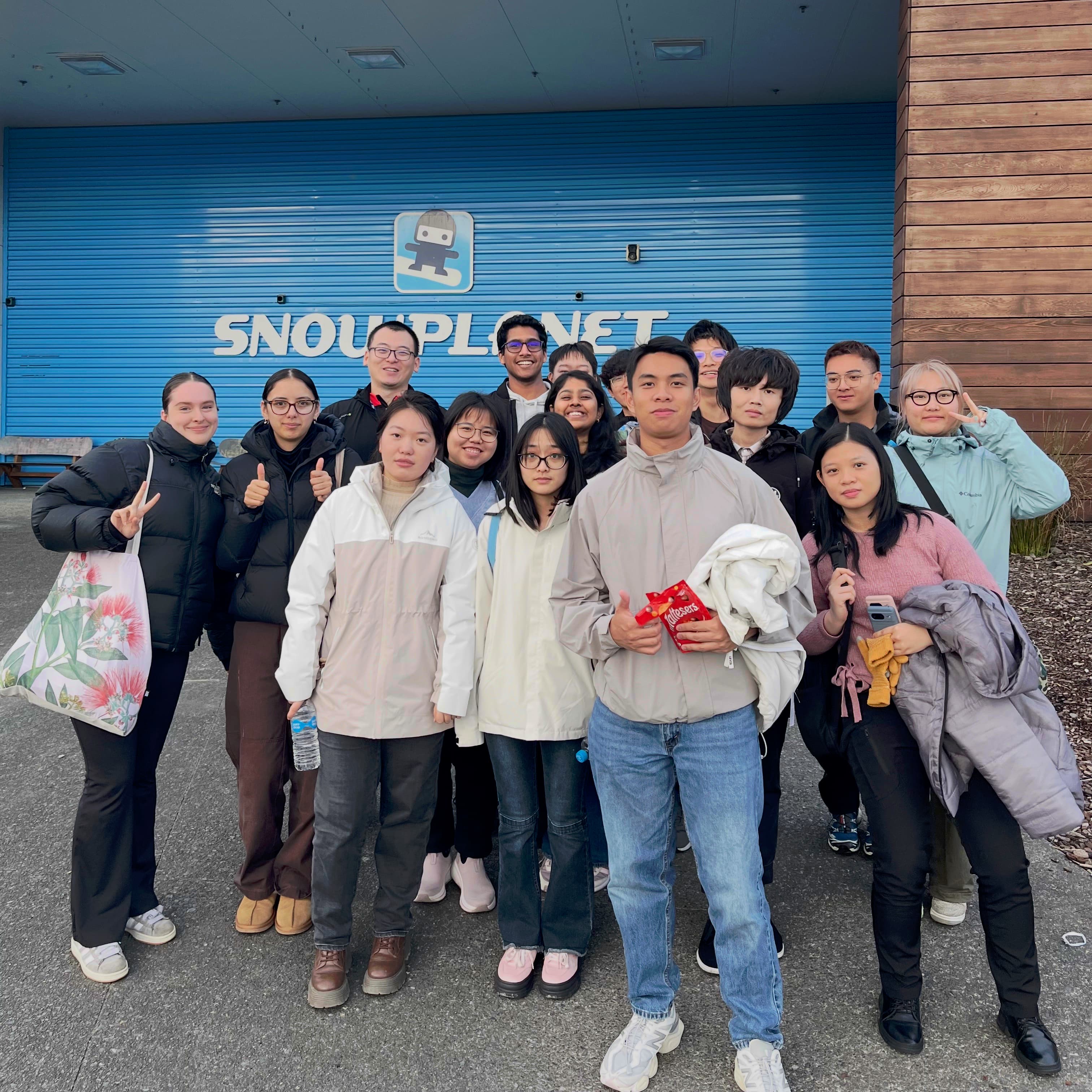 Residents posing together outside Snowplanet on a village trip.